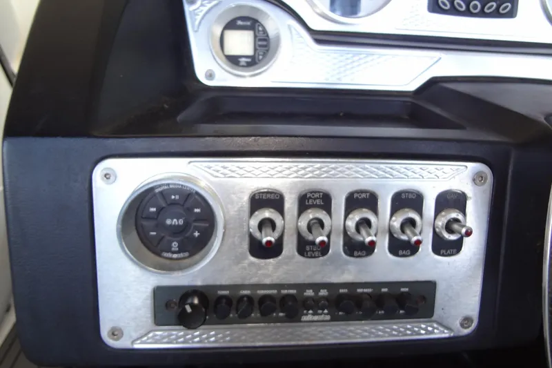 Slide: The Image of Control panel of a 2017 MB SPORTS F22 Tomcat boat with switches and dials. - 14