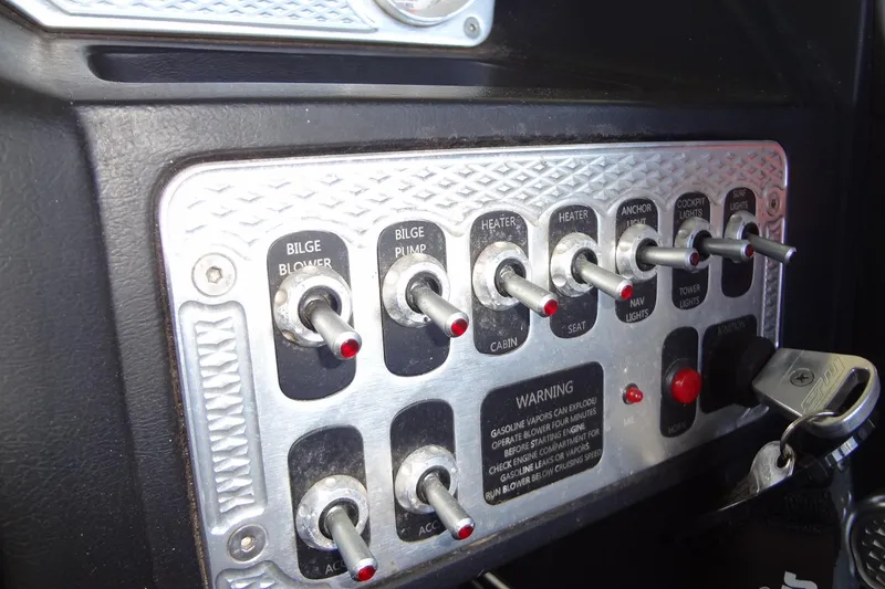 Slide: The Image of Control panel of a 2017 MB SPORTS F22 Tomcat boat with labeled switches. - 15
