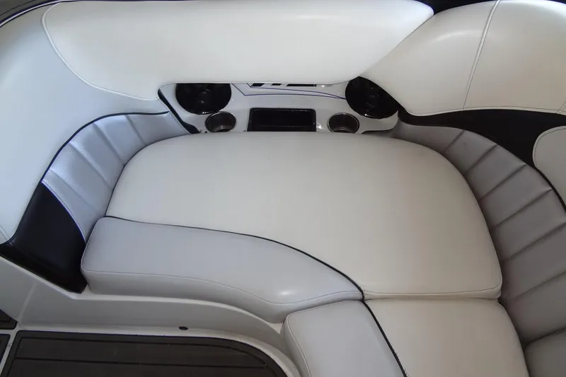 Slide: The Image of 2017 MB SPORTS F22 Tomcat boat interior seating with cup holders and sleek design. - 22