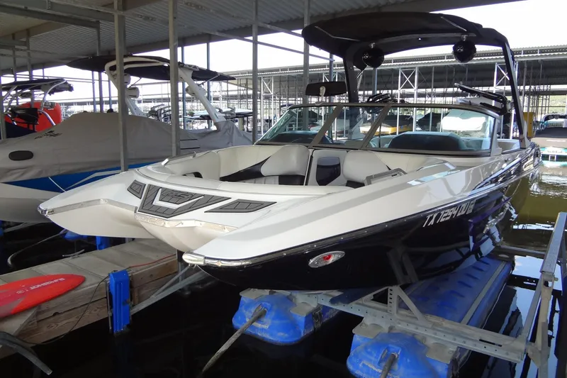 Slide: The Image of 2017 MB SPORTS F22 Tomcat boat docked in a marina, featuring sleek design and modern amenities. - 3