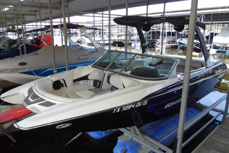 Slide: The Image of 2017 MB SPORTS F22 Tomcat boat docked in marina, sleek design, white and black exterior. - 4