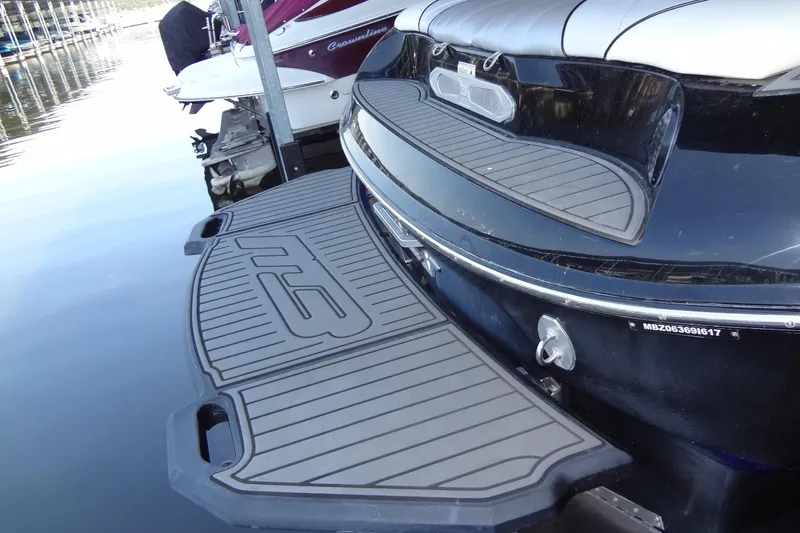 Slide: The Image of 2017 MB SPORTS F22 Tomcat boat with sleek swim platform at dock. - 8