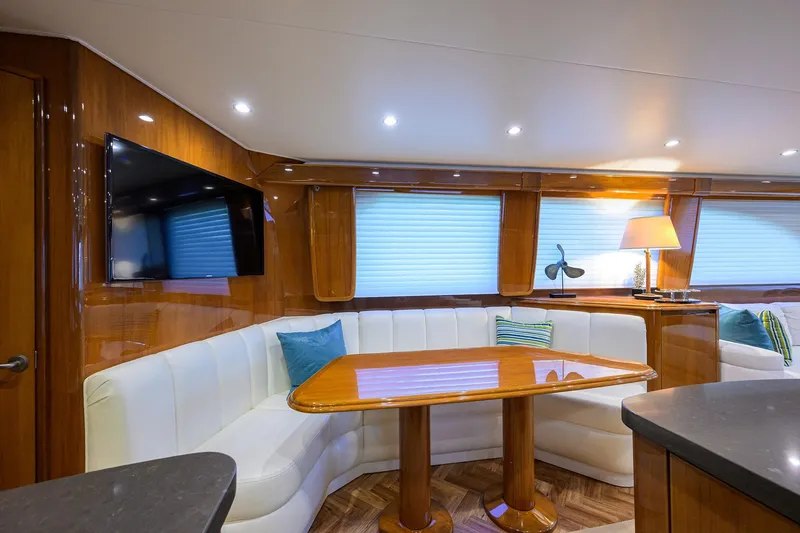 Slide: The Image of Luxurious interior of 2014 Viking 76 Enclosed Bridge Convertible yacht with elegant seating and decor. - 11