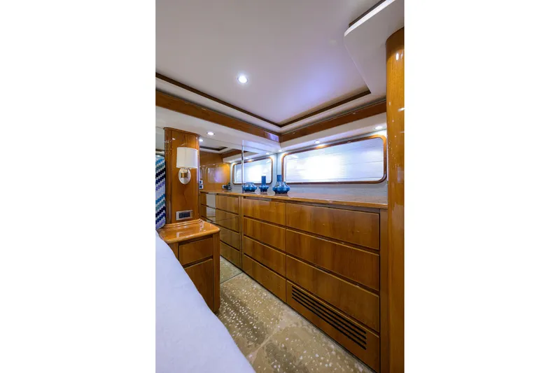 Slide: The Image of Luxurious interior of 2014 Viking 76 Enclosed Bridge Convertible yacht with wooden cabinetry. - 23