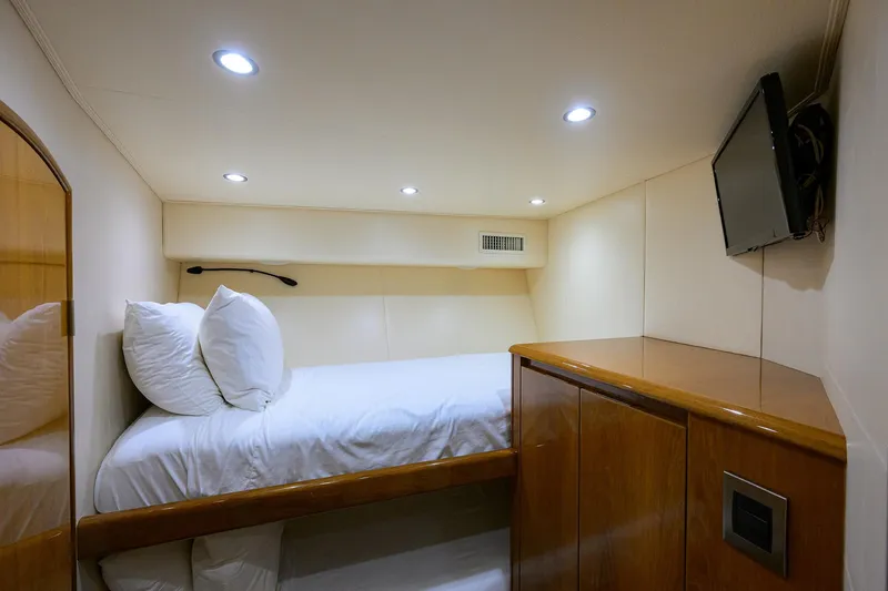 Slide: The Image of Cozy cabin interior of 2014 Viking 76 Enclosed Bridge Convertible yacht with bed and TV. - 29