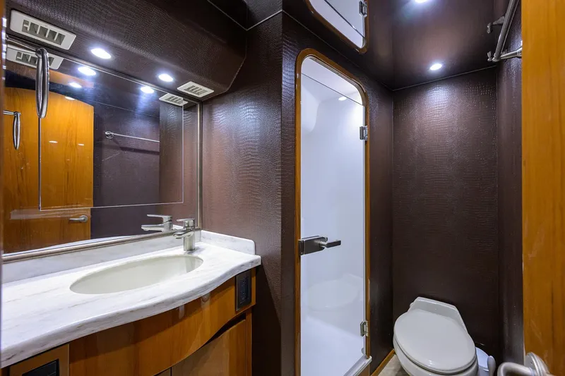 Slide: The Image of Luxurious bathroom in 2014 Viking 76 Enclosed Bridge Convertible yacht, featuring modern fixtures and elegant design. - 36