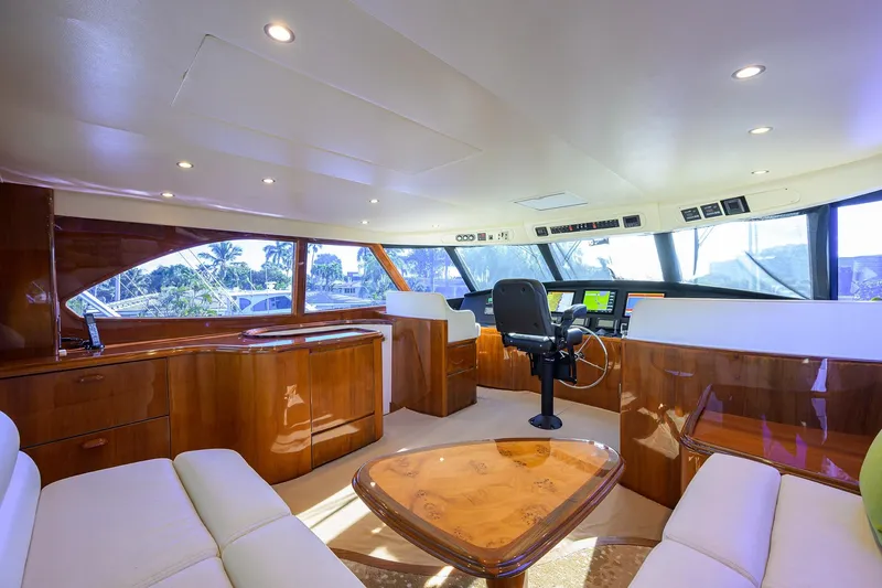 Slide: The Image of Luxurious interior of 2014 Viking 76 Enclosed Bridge Convertible yacht with modern helm. - 39