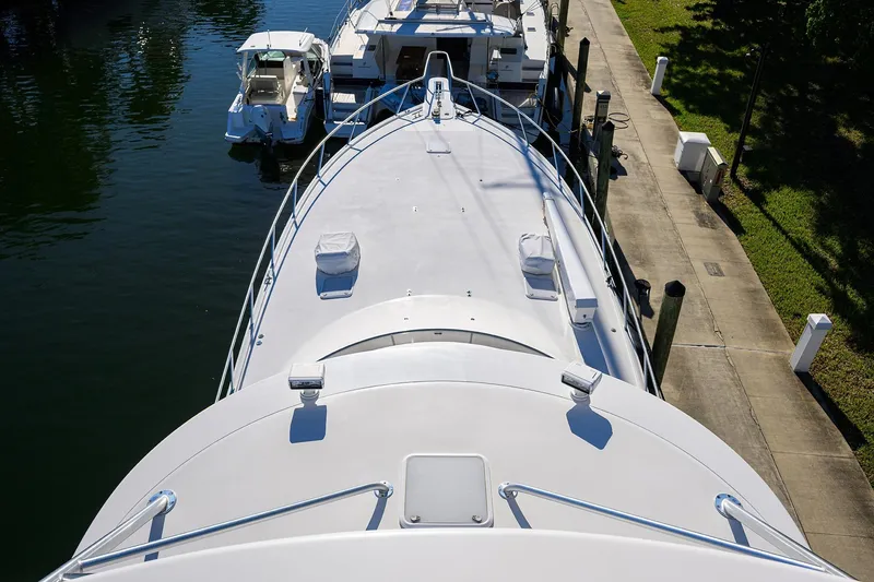 Slide: The Image of 2014 Viking 76 Enclosed Bridge Convertible yacht docked at marina. - 53