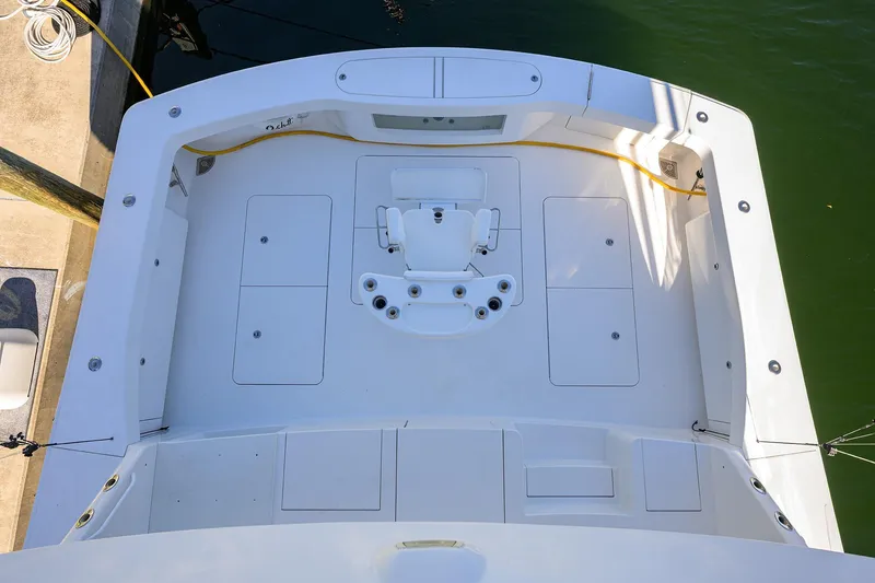 Slide: The Image of 2014 Viking 76 Enclosed Bridge Convertible yacht deck, featuring spacious layout and fishing chair. - 54