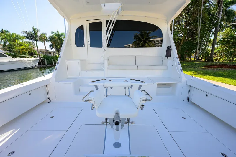 Slide: The Image of 2014 Viking 76 Enclosed Bridge Convertible yacht cockpit with seating and fishing chair. - 57