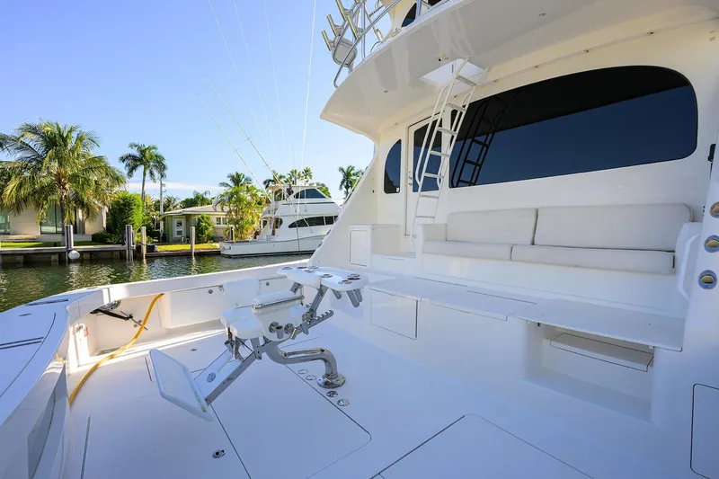 Slide: The Image of 2014 Viking 76 Enclosed Bridge Convertible yacht with spacious deck and seating area. - 58