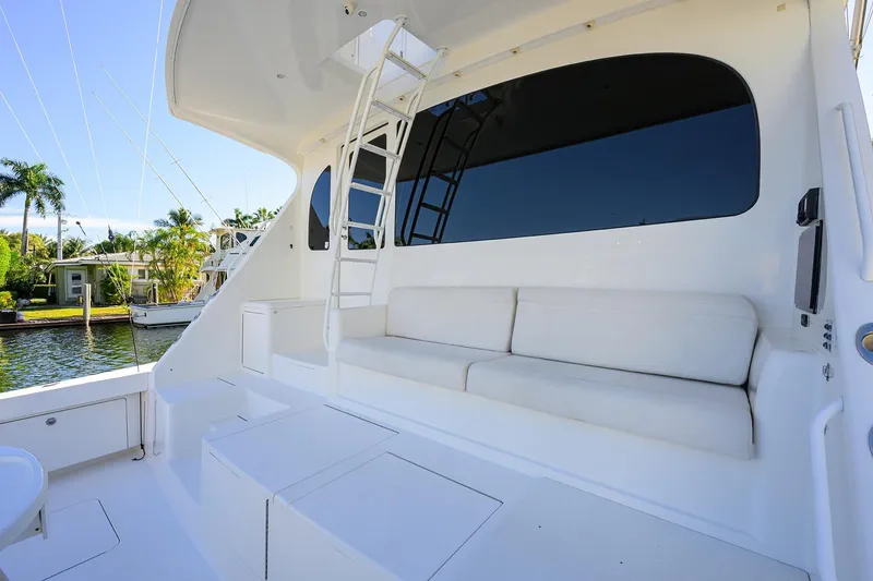 Slide: The Image of 2014 Viking 76 Enclosed Bridge Convertible yacht with white seating and ladder. - 59