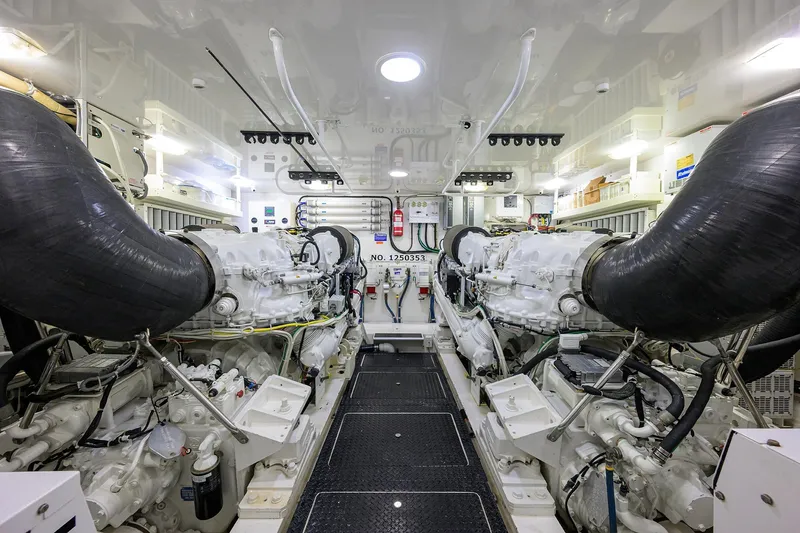 Slide: The Image of Engine room of 2014 Viking 76 Enclosed Bridge Convertible yacht, showcasing dual engines. - 63