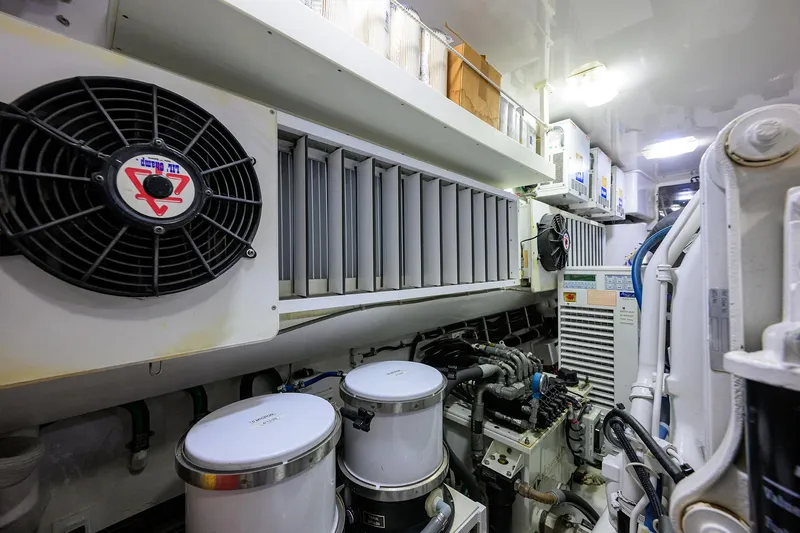Slide: The Image of Engine room of 2014 Viking 76 Enclosed Bridge Convertible yacht, showcasing machinery and ventilation systems. - 69