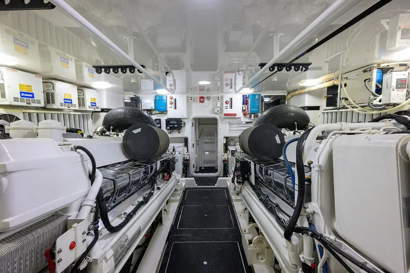 Slide: The Image of Engine room of 2014 Viking 76 Enclosed Bridge Convertible yacht, showcasing dual engines. - 70