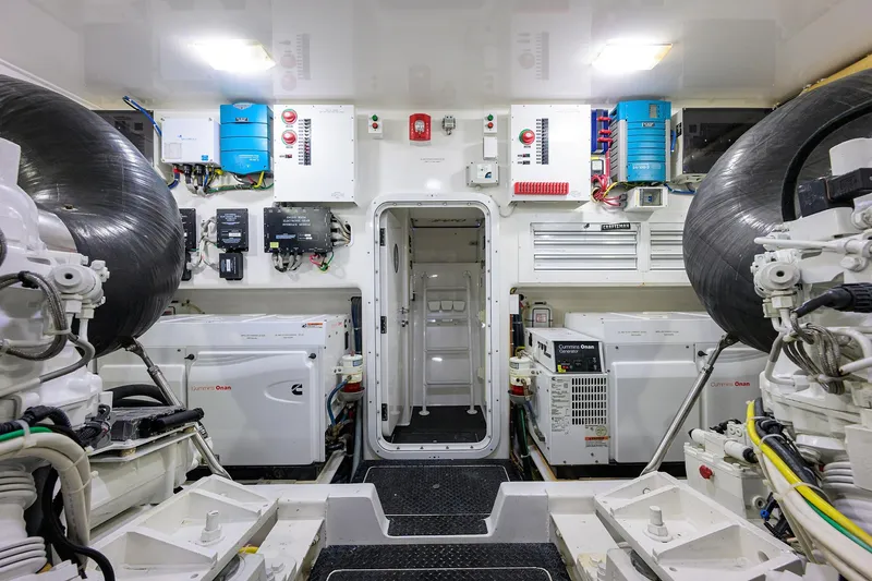 Slide: The Image of Engine room of 2014 Viking 76 Enclosed Bridge Convertible yacht, featuring Cummins Onan generators. - 71