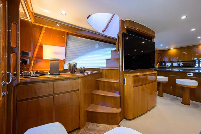 Slide: The Image of Luxurious interior of 2014 Viking 76 Enclosed Bridge Convertible yacht with wooden finishes. - 9