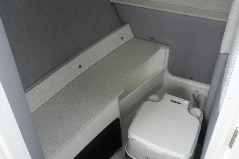 Slide: The Image of 2026 Cobalt R6 boat interior with compact toilet and seating area. - 15