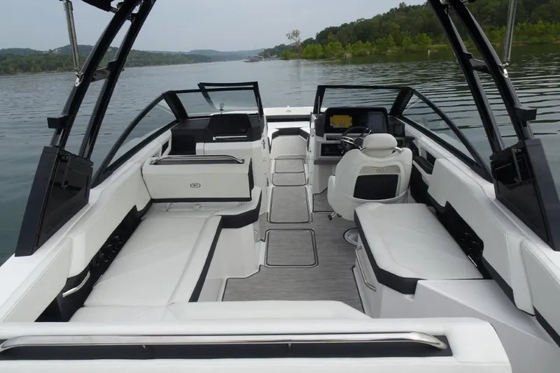 Slide: The Image of 2026 Cobalt R6 boat interior with sleek white seating and modern dashboard on a serene lake. - 7
