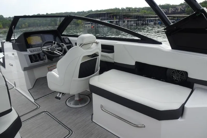 Slide: The Image of 2026 Cobalt R6 boat interior with white seating and modern dashboard on a lake. - 9