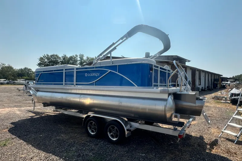 Slide: The Image of 2024 Godfrey SWEETWATER 2286 SB pontoon boat on trailer, parked outdoors. - 17