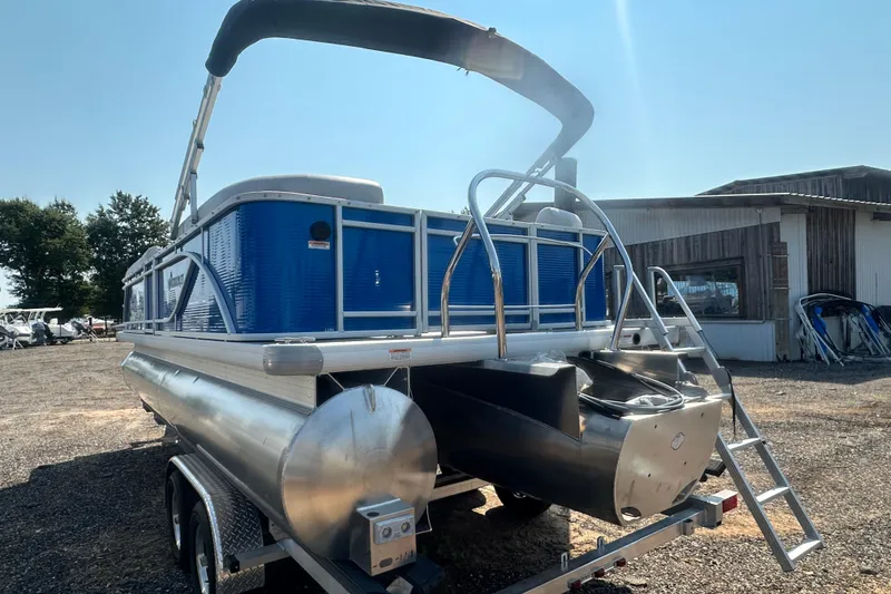 Slide: The Image of 2024 Godfrey SWEETWATER 2286 SB pontoon boat with blue exterior, parked outdoors. - 18