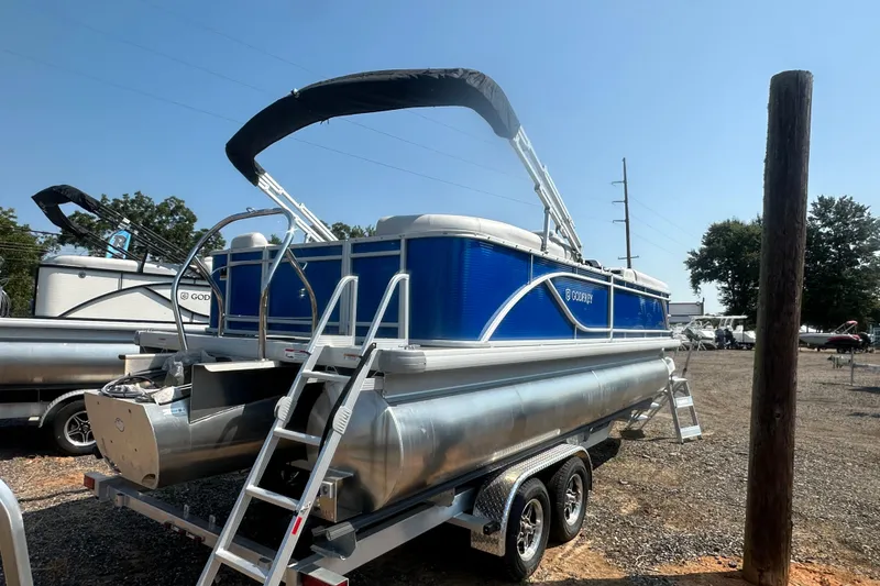 Slide: The Image of 2024 Godfrey SWEETWATER 2286 SB pontoon boat with blue exterior on a trailer. - 19