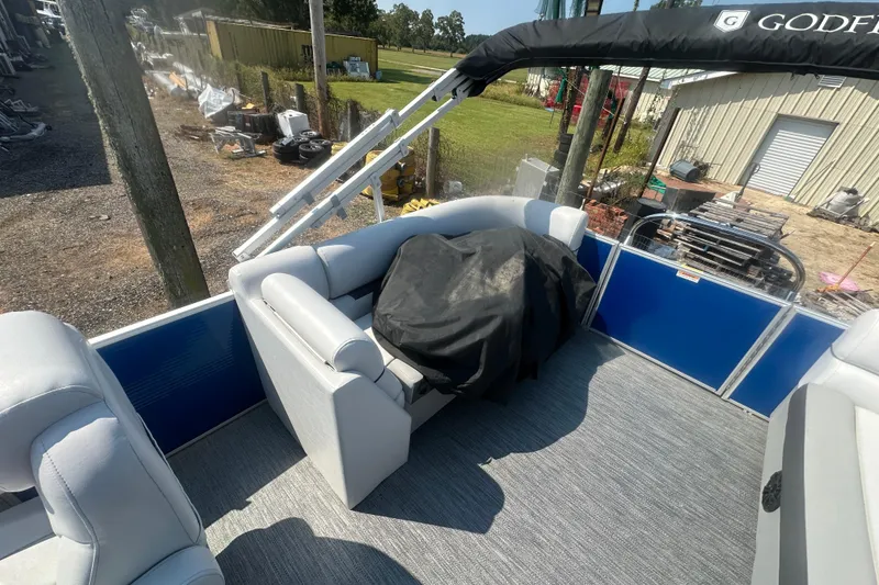 Slide: The Image of 2024 Godfrey SWEETWATER 2286 SB pontoon boat interior with seating and covered equipment. - 28