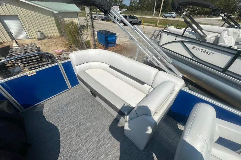 Slide: The Image of 2024 Godfrey SWEETWATER 2286 SB pontoon boat with white seating and blue paneling. - 29