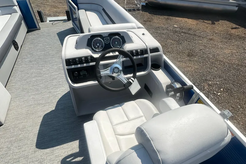 Slide: The Image of 2024 Godfrey SWEETWATER 2286 SB boat interior with steering wheel and seating. - 30