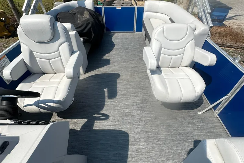 Slide: The Image of 2024 Godfrey SWEETWATER 2286 SB boat interior with white seating and blue accents. - 34