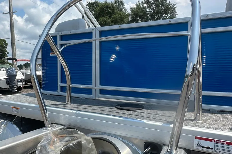 Slide: The Image of 2024 Godfrey SWEETWATER 2286 SB pontoon boat with blue paneling and stainless steel railings. - 8