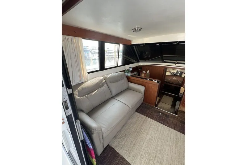 Slide: The Image of Interior of 1978 Silverton F32 boat with leather sofa and wooden accents. - 10
