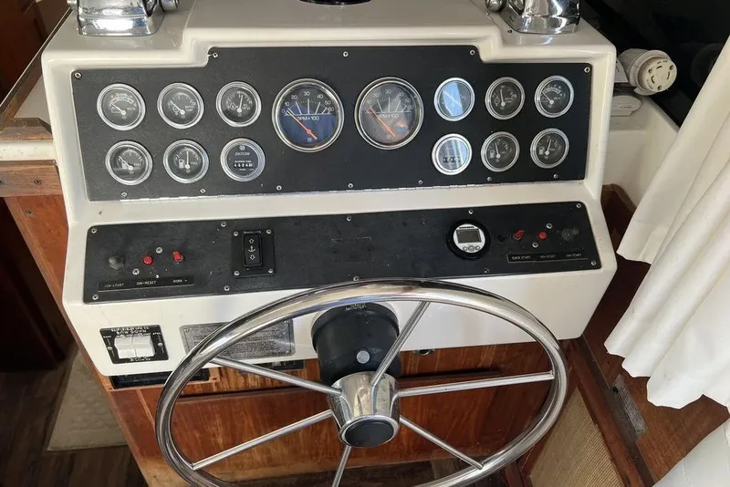 Slide: The Image of 1978 Silverton F32 boat dashboard with gauges and steering wheel. - 14