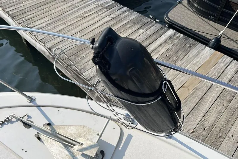 Slide: The Image of 1978 Silverton F32 boat with black fender and anchor at dockside. - 23