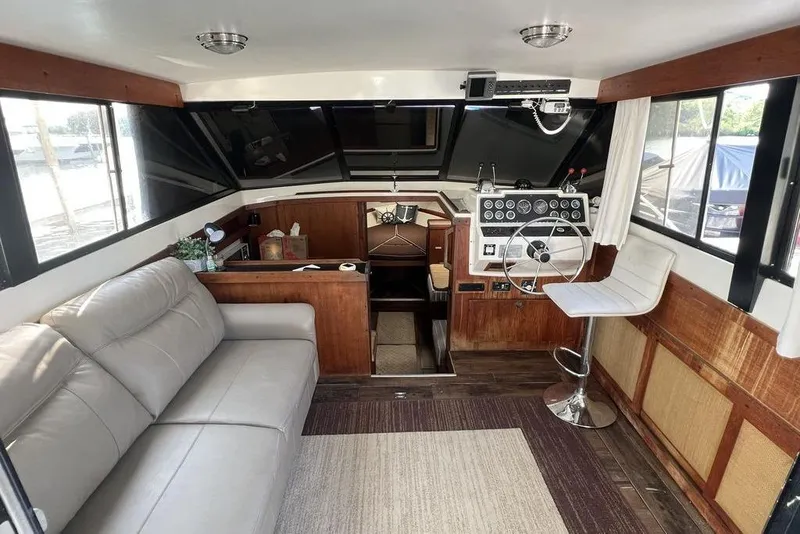 Slide: The Image of 1978 Silverton F32 boat interior with helm, seating, and wood accents. - 7