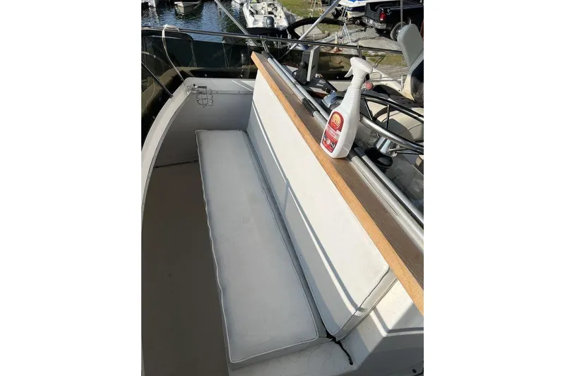 Slide: The Image of 1978 Silverton F32 boat interior with white seating and cleaning product on the helm. - 9