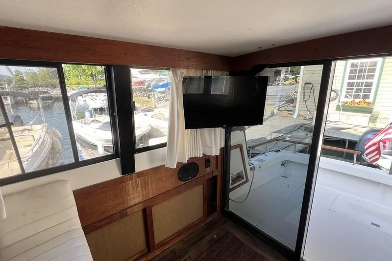 Slide: The Image of Interior of a 1978 Silverton F32 boat with dockside view and mounted TV. - 11