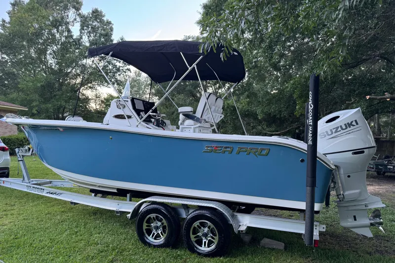 The Image of 2022 Sea Pro 219 Center Console boat on trailer, featuring Suzuki outboard motor. - 0