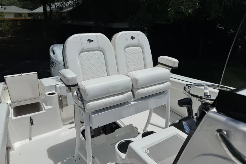 Slide: The Image of 2022 Sea Pro 219 Center Console boat with dual white cushioned seats. - 10