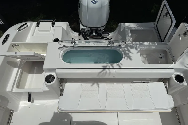 Slide: The Image of 2022 Sea Pro 219 Center Console boat interior with storage compartments and seating. - 12