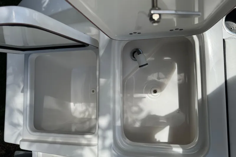 Slide: The Image of 2022 Sea Pro 219 Center Console boat sink and storage compartments. - 14