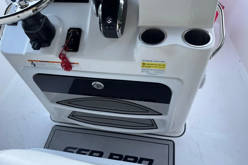 Slide: The Image of 2022 Sea Pro 219 Center Console helm with steering wheel and cup holders. - 20