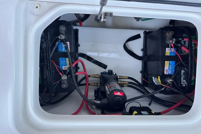 Slide: The Image of 2022 Sea Pro 219 Center Console battery compartment with wiring and components. - 21