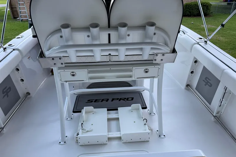 Slide: The Image of 2022 Sea Pro 219 Center Console boat interior with rod holders and storage compartments. - 22