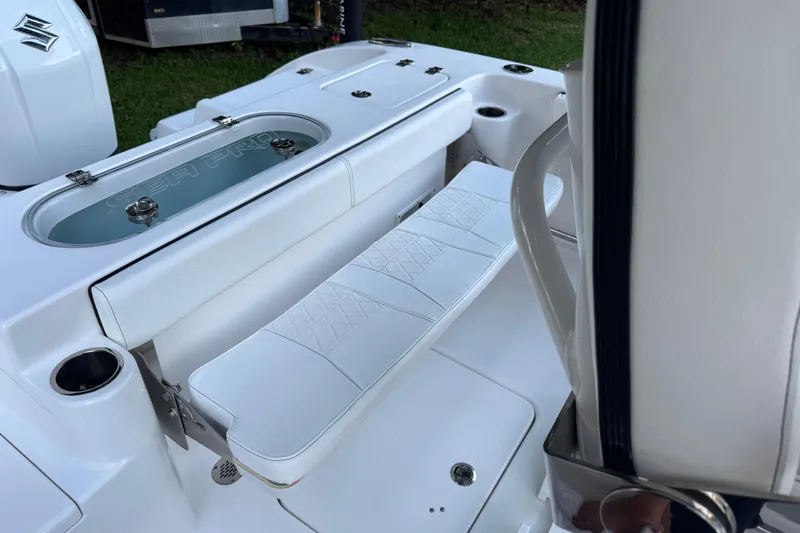 Slide: The Image of 2022 Sea Pro 219 Center Console boat interior with white seating and livewell. - 23
