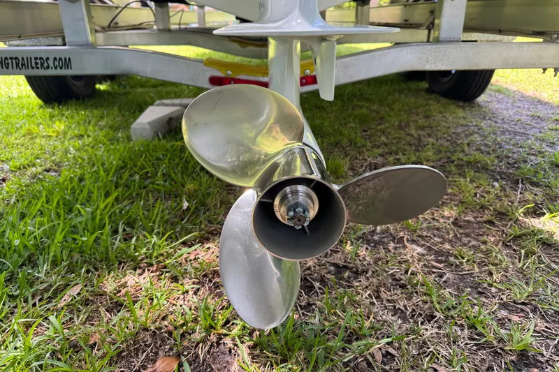 Slide: The Image of Propeller of 2022 Sea Pro 219 Center Console boat on grass near trailer. - 5