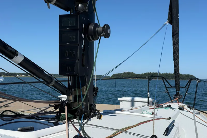 Slide: The Image of 2018 J Boats J/121 sailboat cockpit with digital displays, ropes, and scenic water view. - 12