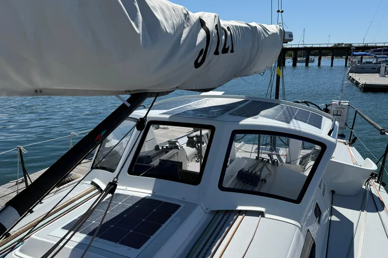 Slide: The Image of 2018 J Boats J/121 sailboat docked, featuring sleek design and solar panels. - 13