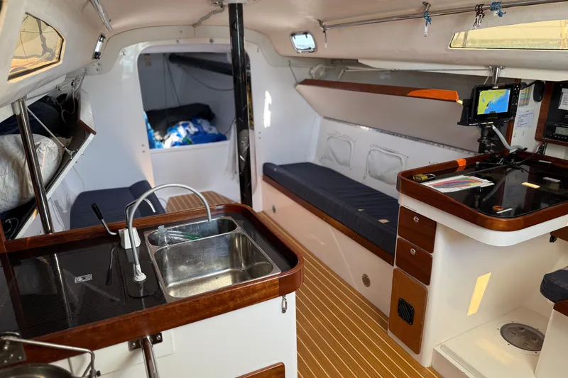 Slide: The Image of 2018 J Boats J/121 interior with kitchenette, seating, and navigation equipment. - 21